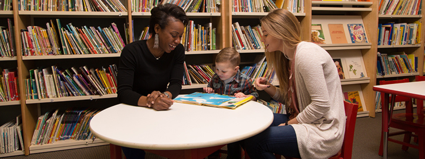 Teachers helping student read