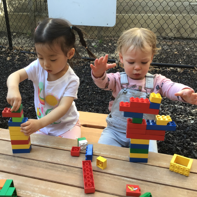 Toddlers Playing With Blocks Outside